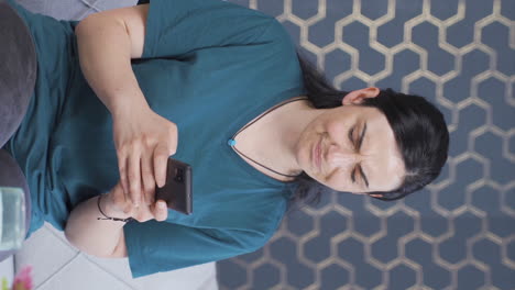 Vertical-video-of-Disappointed-woman-texting.